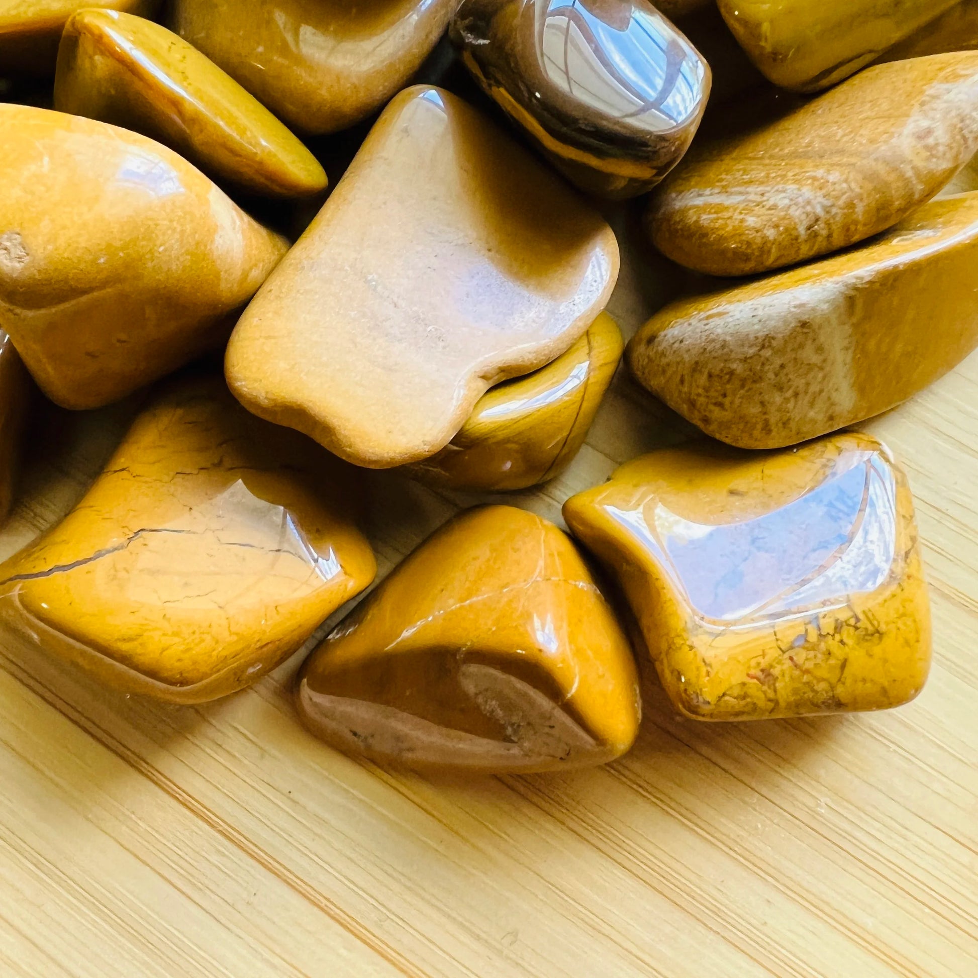 Side angle of Yellow Jasper tumbled stone, showing matte finish, from Madagascar.