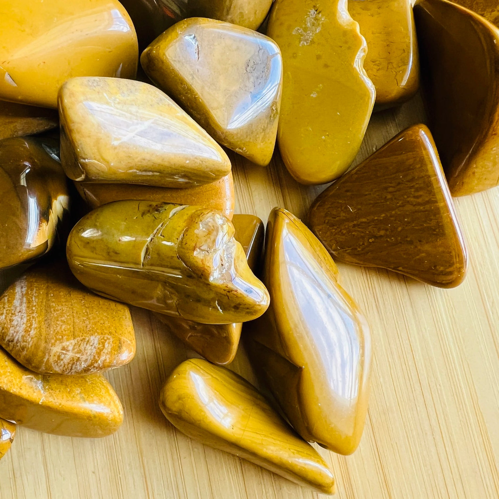 Top-down shot of Yellow Jasper tumbled stone, from Sofia, Madagascar.