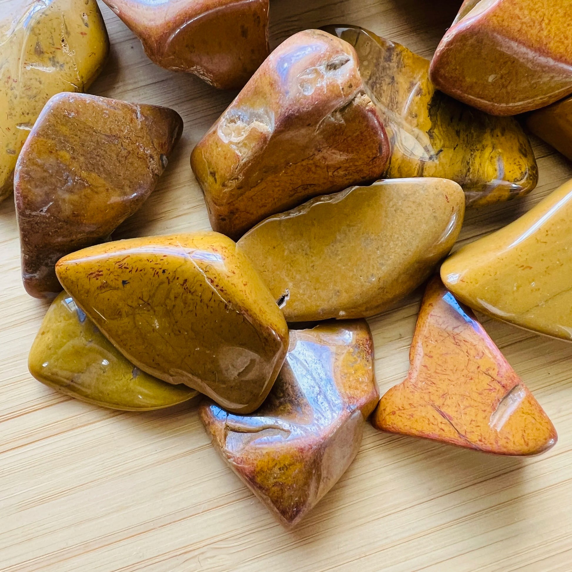 Macro view of Yellow Jasper tumbled stone, showing soft luster, Madagascar-sourced.