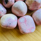 Detail capture of Rhodonite tumbled stone, showing characteristic color, from Ancash, Peru.