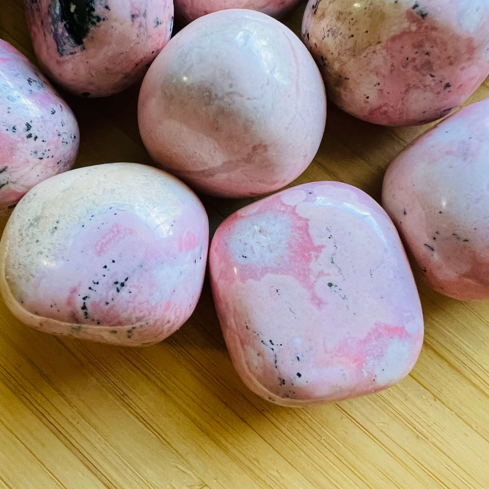 Detail capture of Rhodonite tumbled stone, showing characteristic color, from Ancash, Peru.