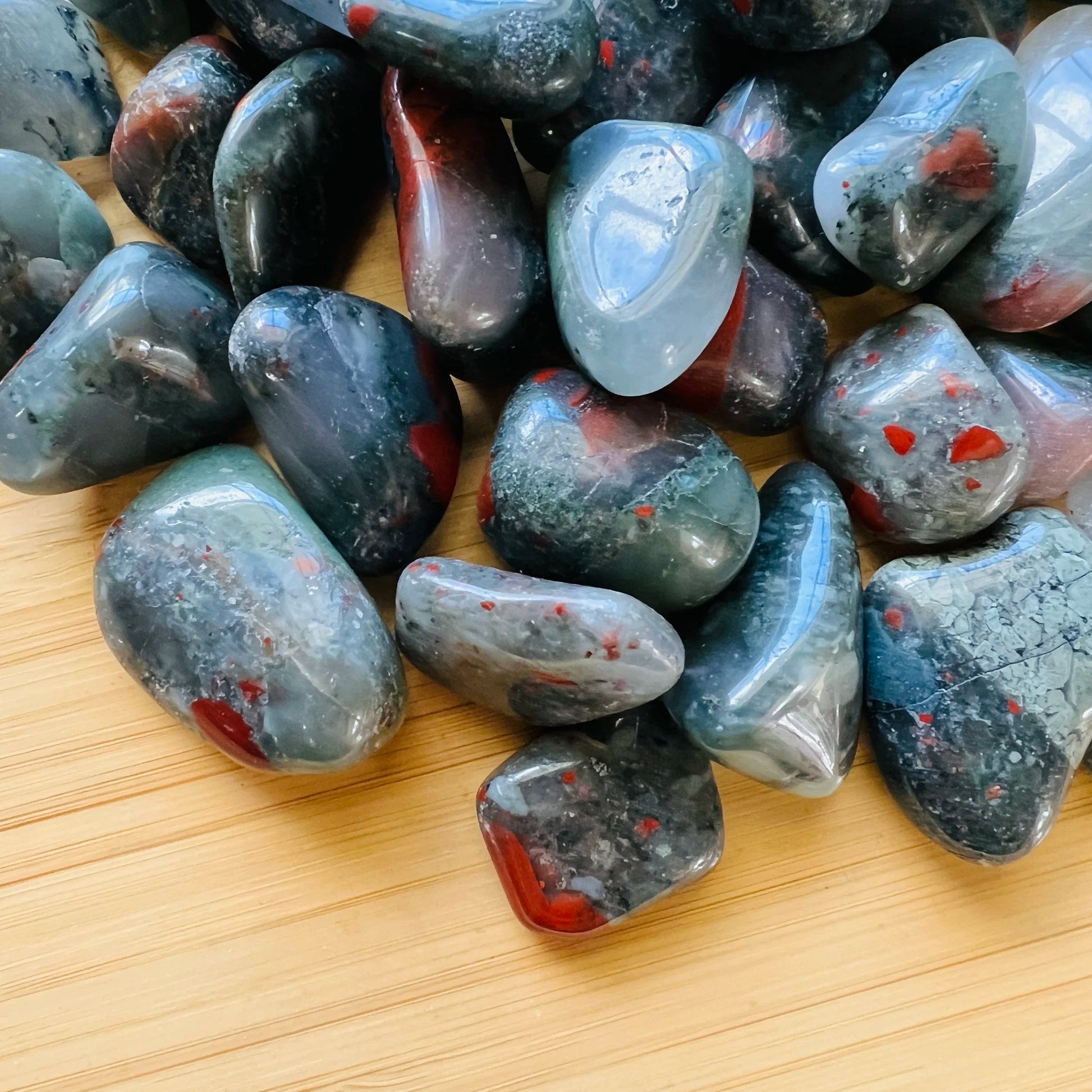 Natural surface of Bloodstone tumbled stone, sourced from Hhohho, Eswatini.