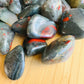 Underside view of Bloodstone tumbled stone, showing characteristic patterning.