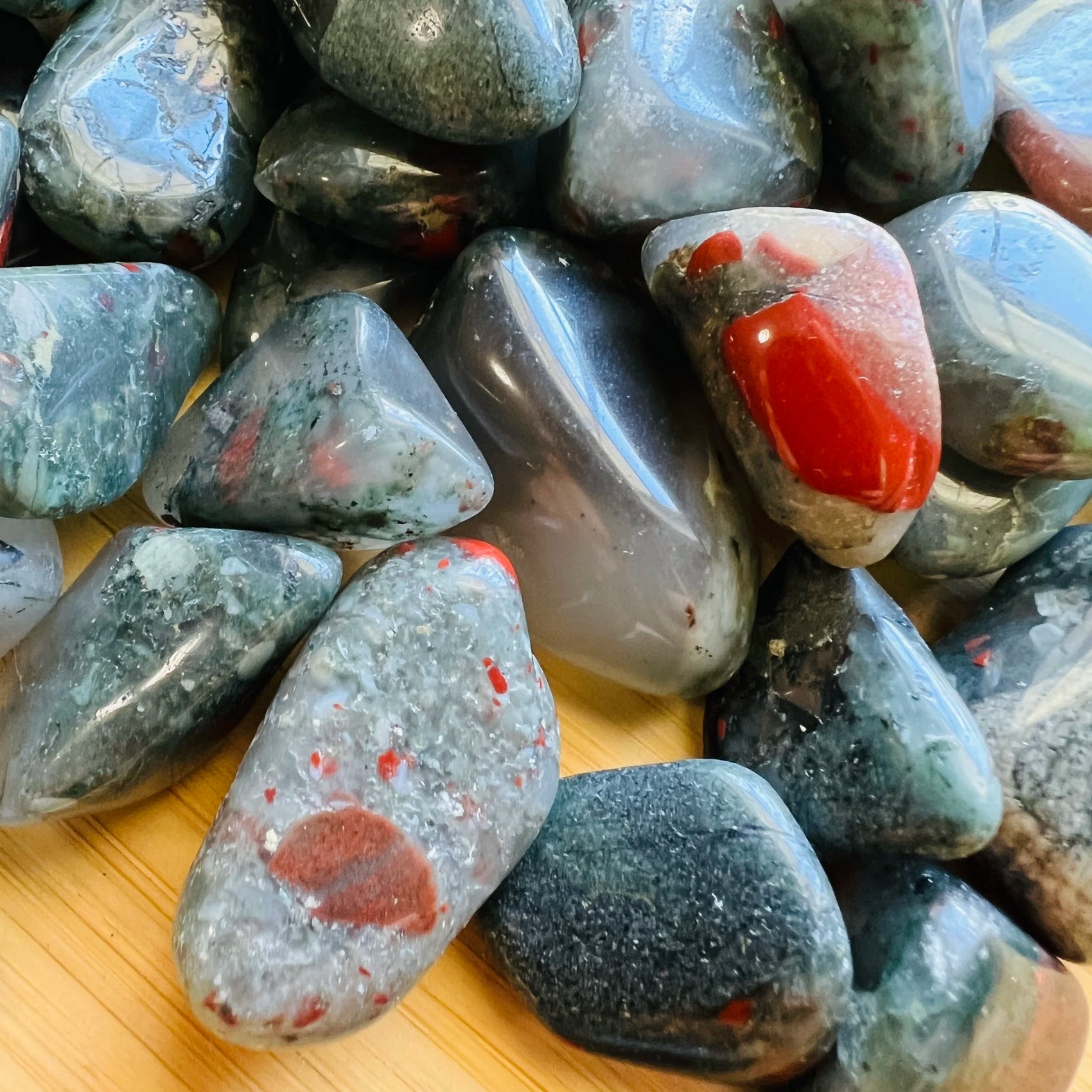 Detail of Bloodstone tumbled stone, often kept for Energy.