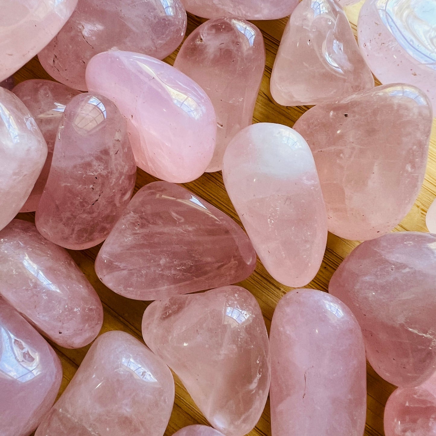 Back view of Grade AA Rose Quartz tumbled stone showing natural surface