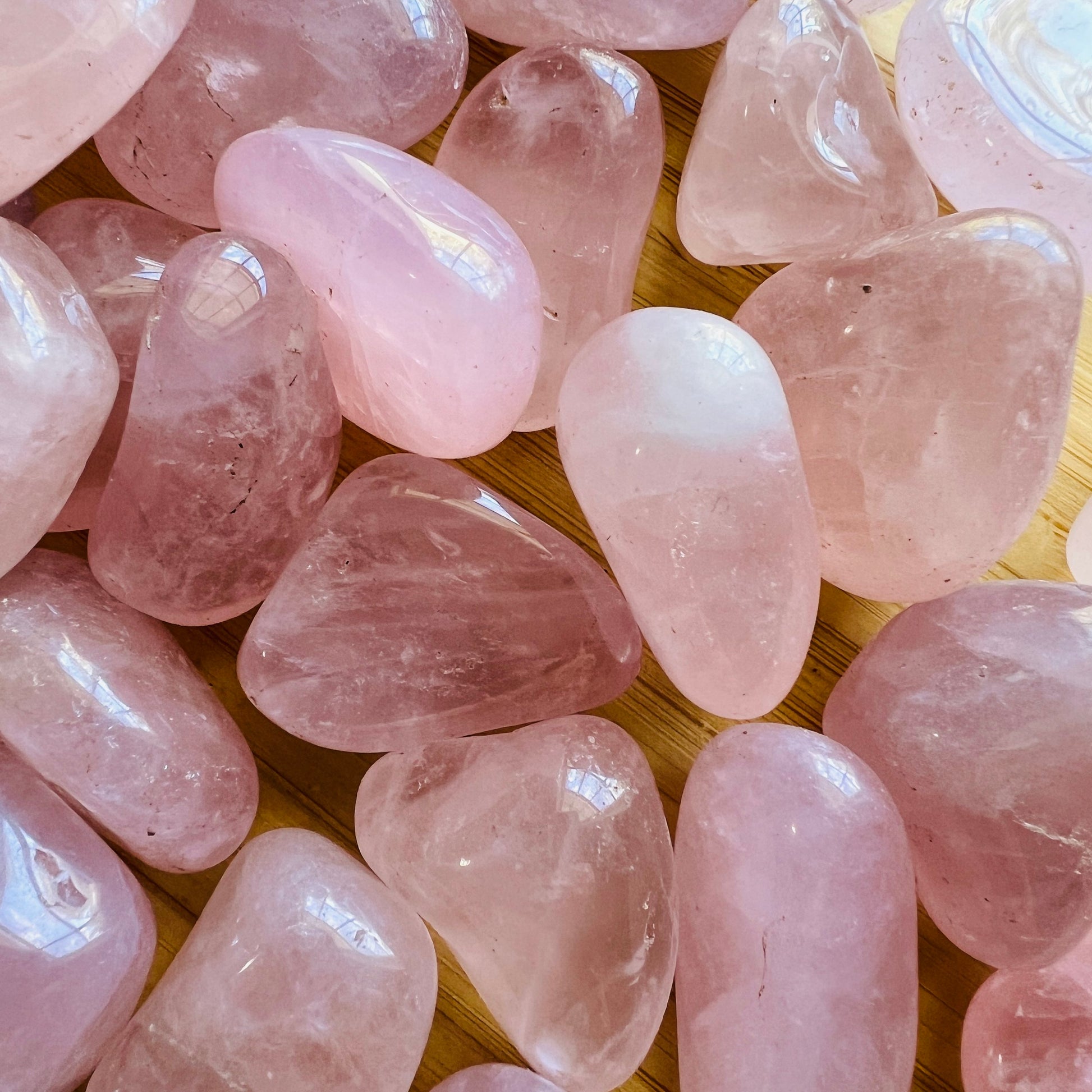 Back view of Grade AA Rose Quartz tumbled stone showing natural surface