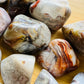 Alternate angle of Grade A Crazy Lace Agate tumbled stone showing overall shape
