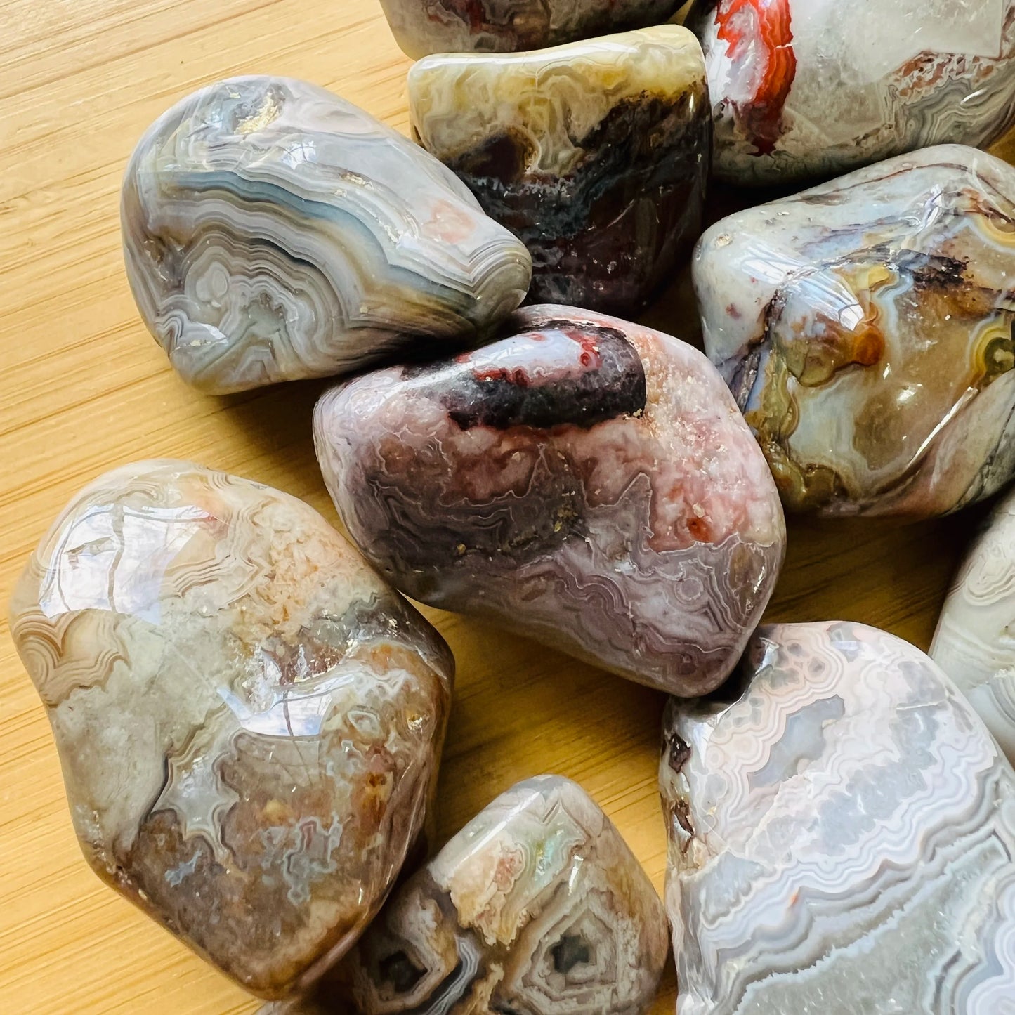 Top view of Grade A Crazy Lace Agate tumbled stone, sourced from Chihuahua, Mexico