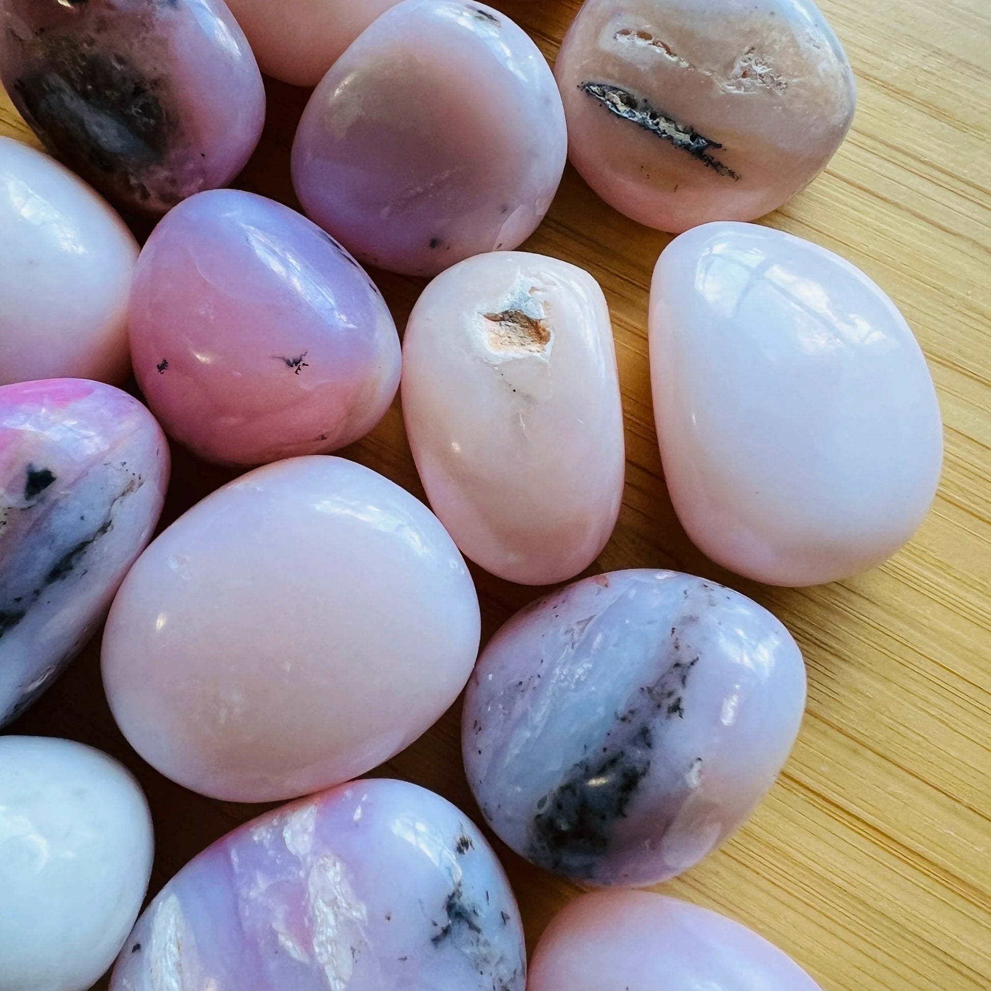 Rear view of Grade A Pink Opal tumbled stone, from Ica, Peru.