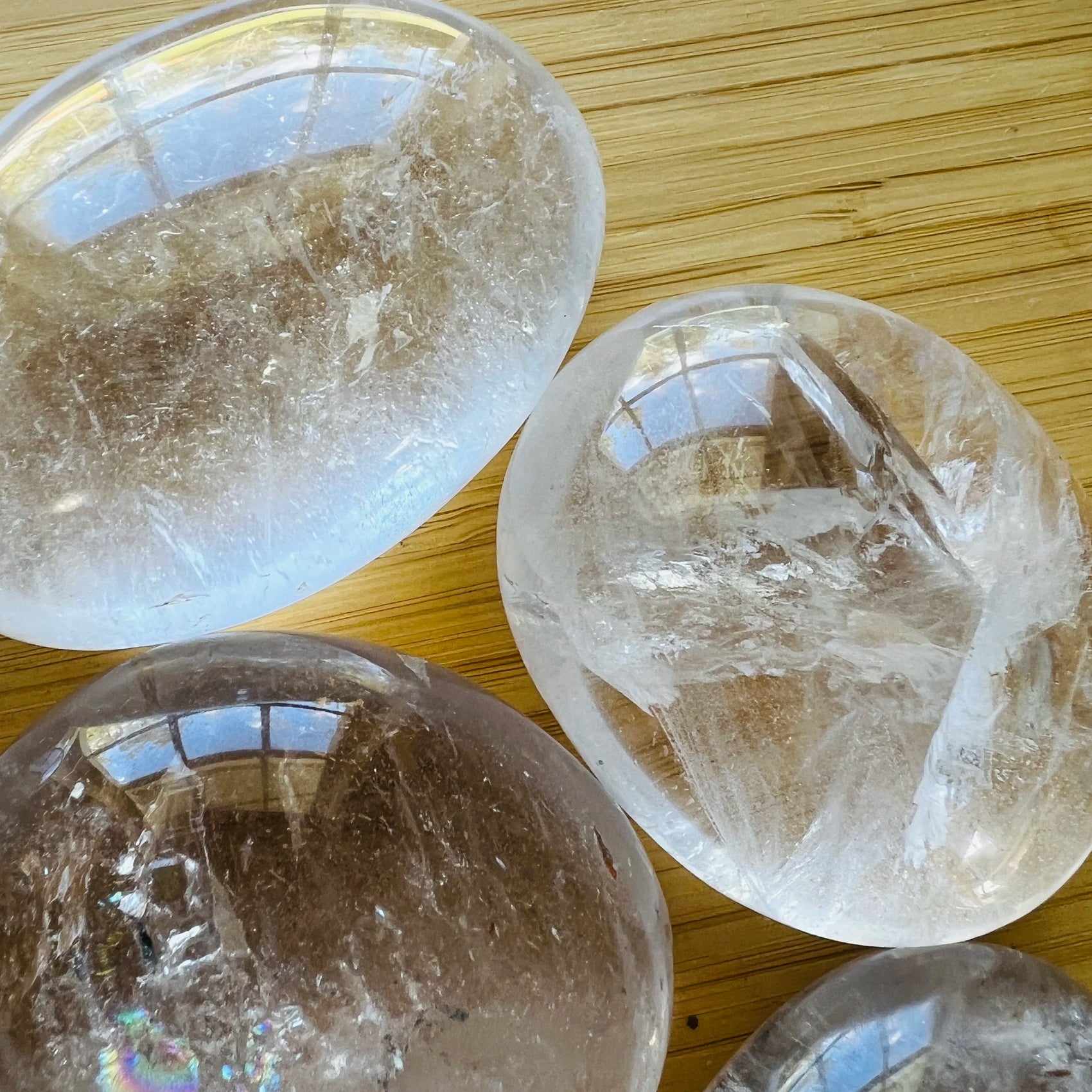 Bottom side of Clear Quartz palm stone, showing subtle veining, traditionally used for Cleansing and Meditation.