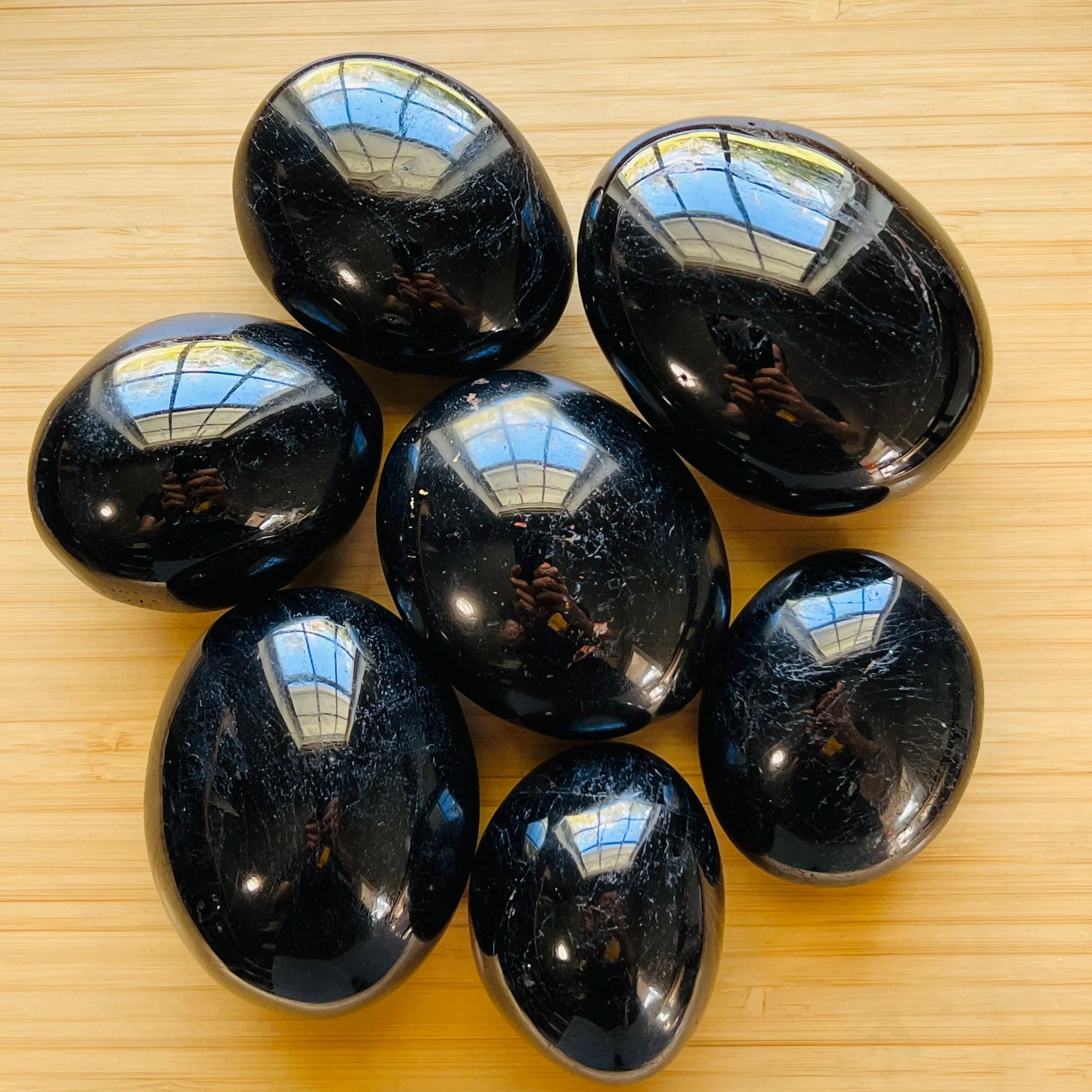 Black Tourmaline palm stone in Black tones, ethically sourced from Madagascar for Stress Relief and Cleansing