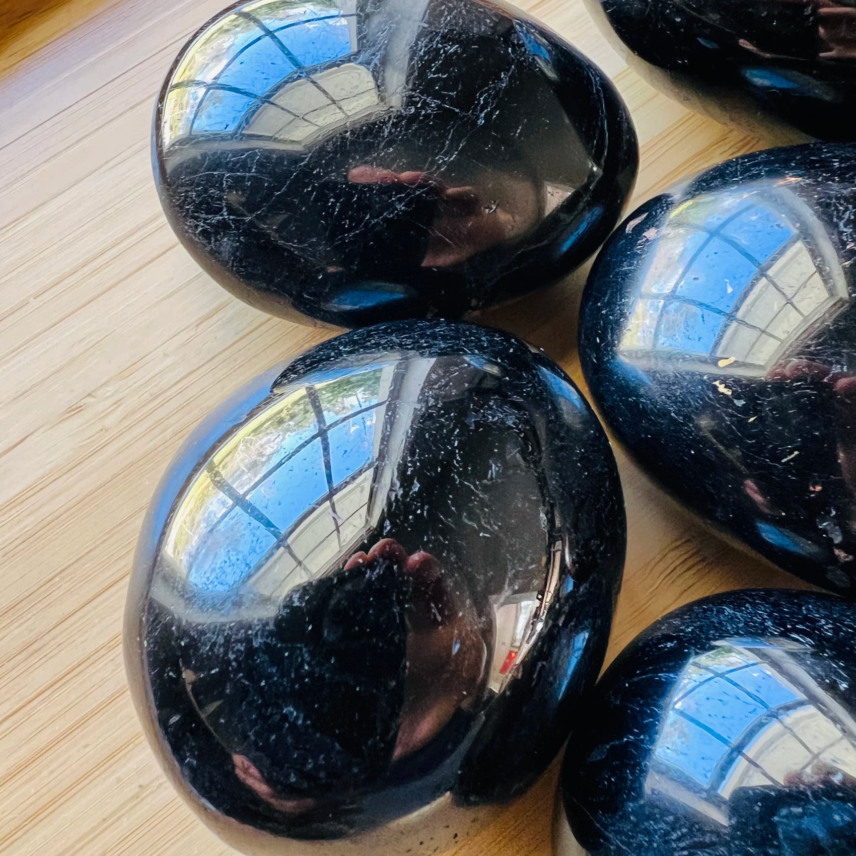 Close-up of Black Tourmaline palm stone from Madagascar, soothing wellness stone for Stress Relief