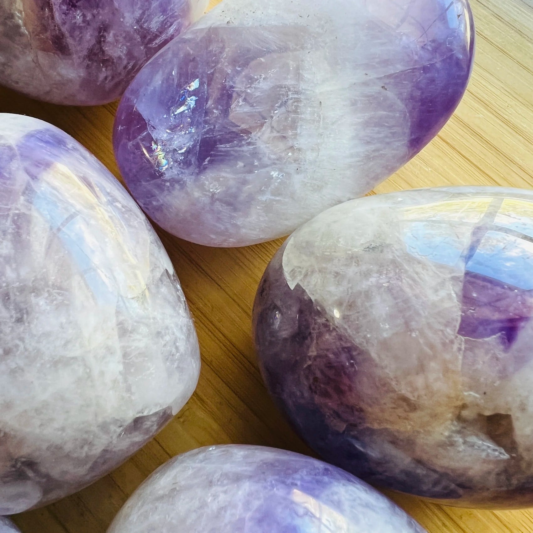 Back view of Grade A Banded Amethyst palm stone showing natural surface