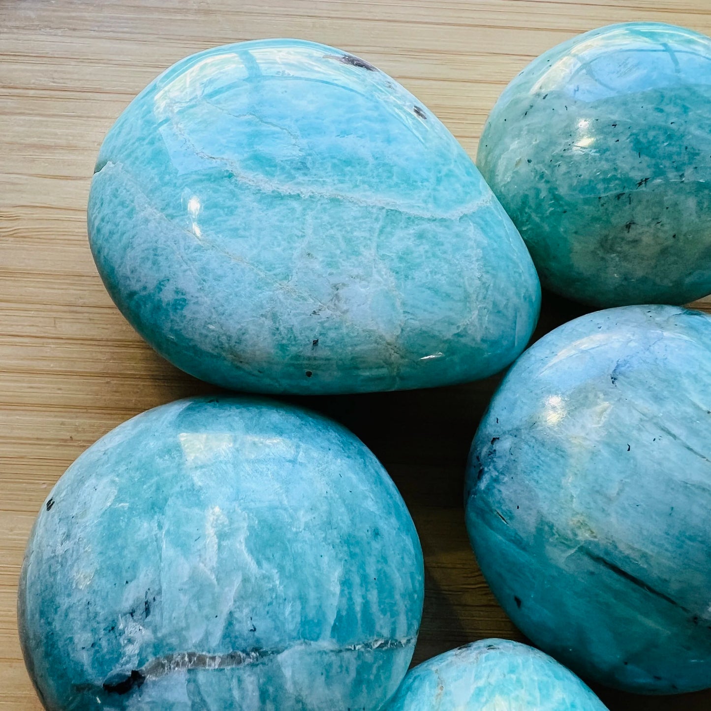 Underside detail of Amazonite palm stone, showing color depth, drawn on for Stress Relief and Emotional Healing.