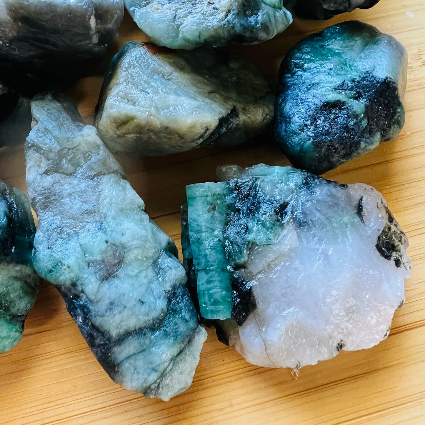 Sideways view of Grade A Emerald raw stone, Brazil-sourced, drawn on for Love.