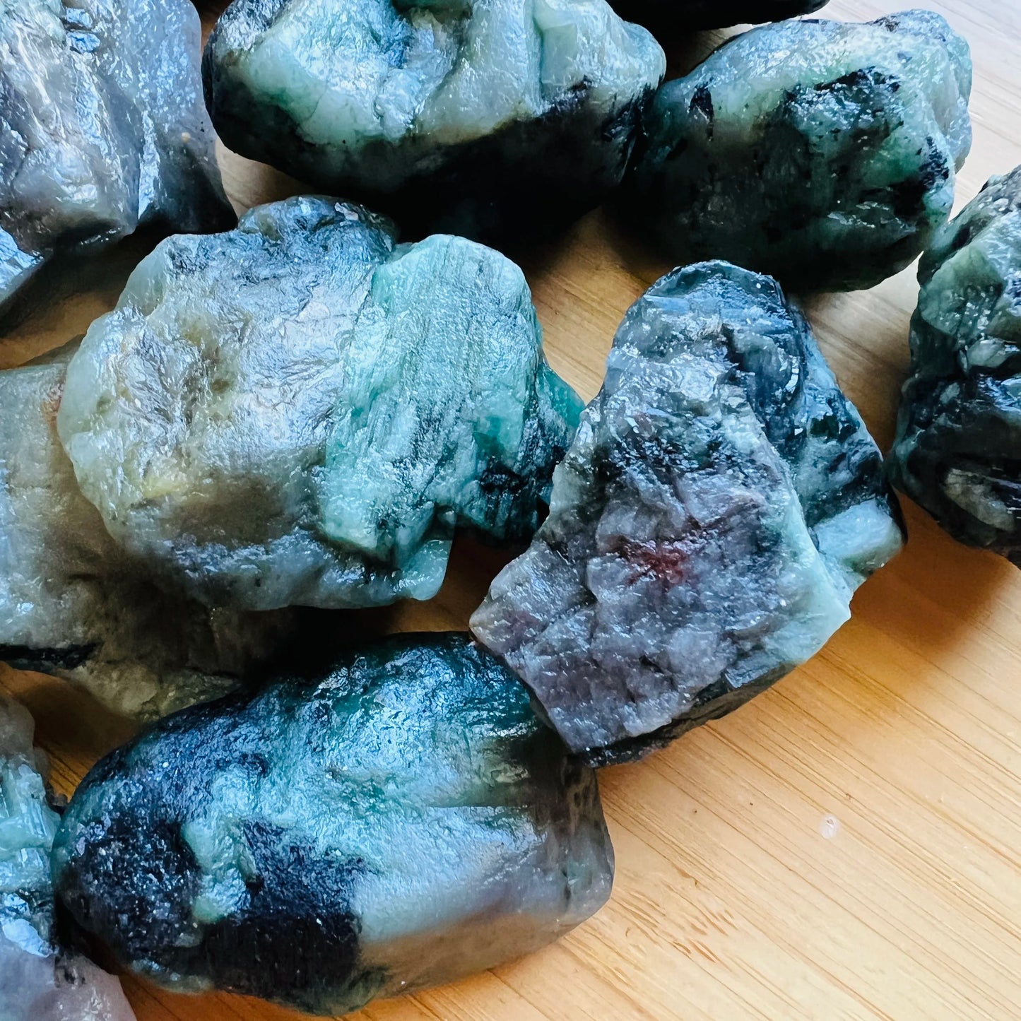 Top angle of Emerald raw stone, showing natural banding.