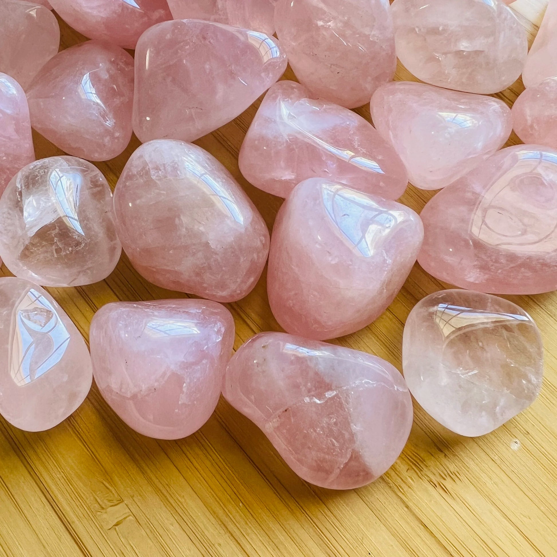 Close-up detail of Grade AA Rose Quartz tumbled stone showing natural pink tones and texture