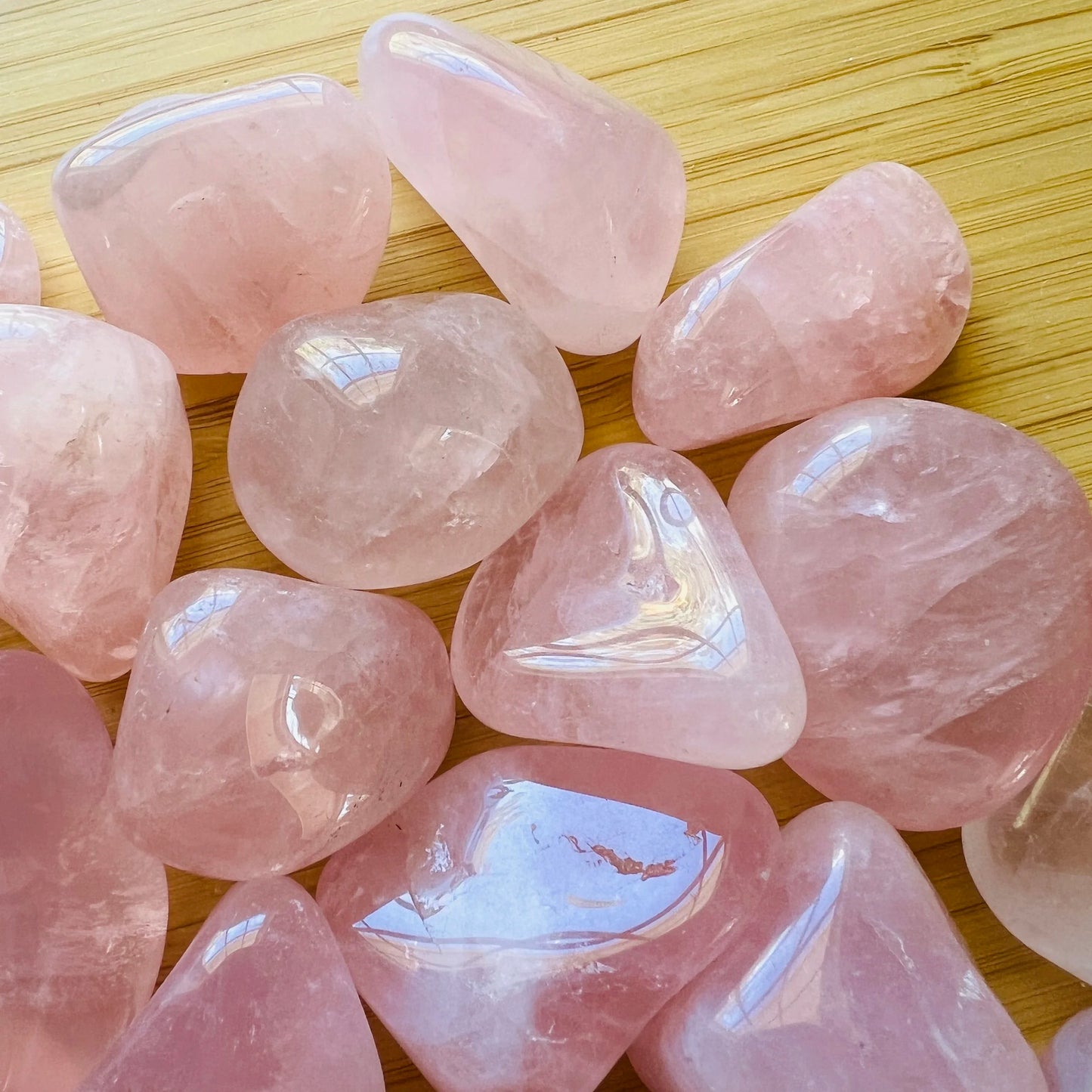 Alternate angle of Grade AA Rose Quartz tumbled stone showing overall shape