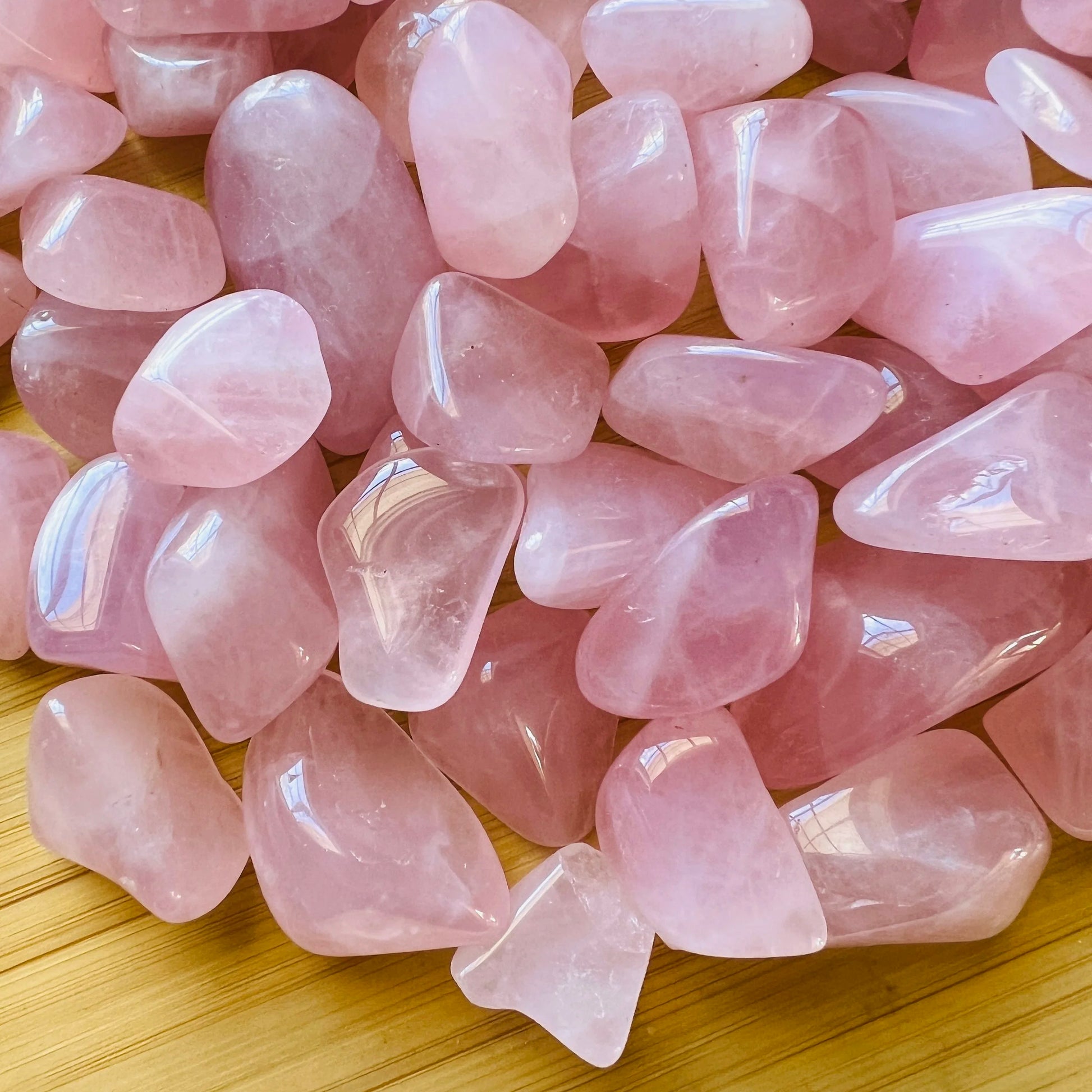 Surface detail of Rose Quartz tumbled stone, showing natural sheen.