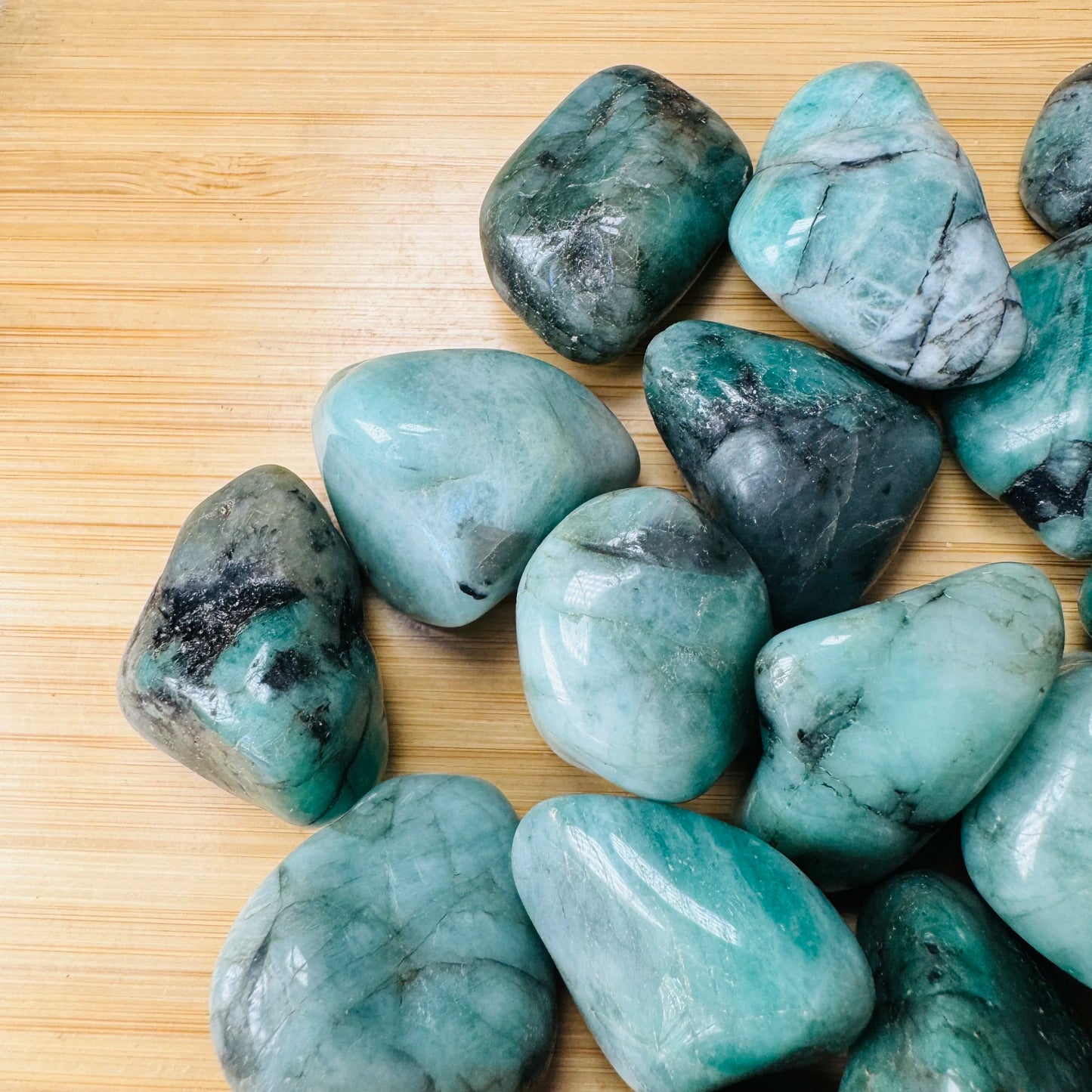 Reverse side of Emerald tumbled stone, showing characteristic color.