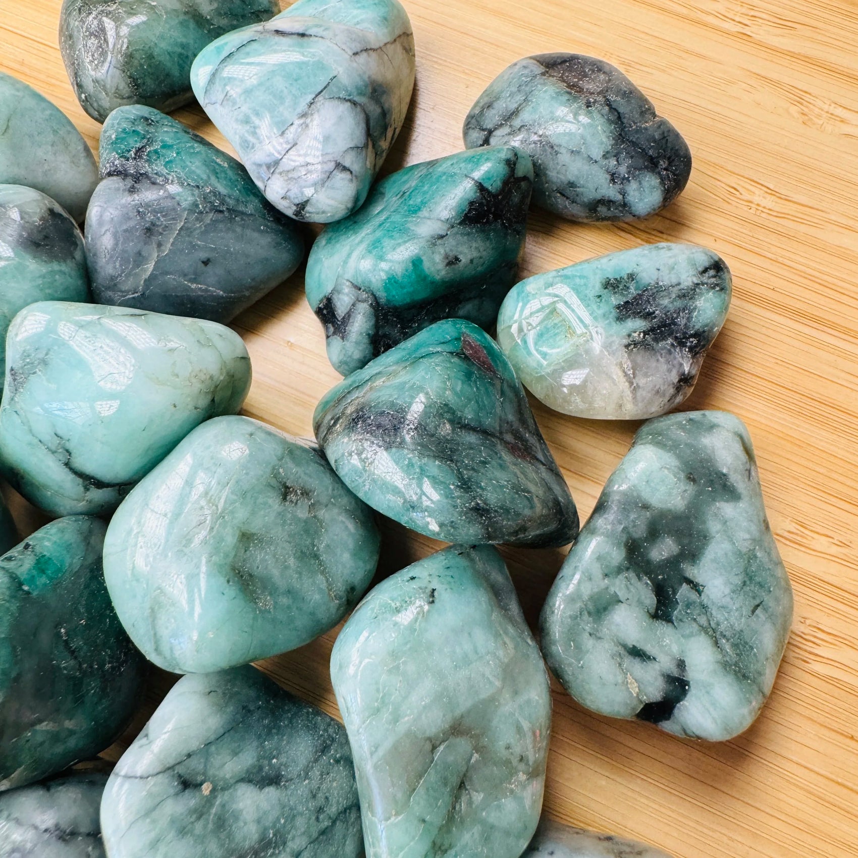 Close-up of Emerald tumbled stone from Brazil, soothing wellness stone for Healing