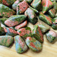 Close-up of Grade AA Unakite tumbled stone, showing characteristic color, hand-selected from Northern Cape, South Africa.