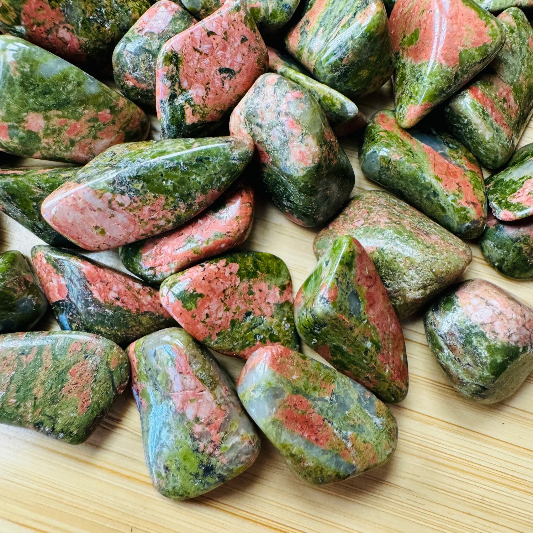Close-up of Grade AA Unakite tumbled stone, showing characteristic color, hand-selected from Northern Cape, South Africa.