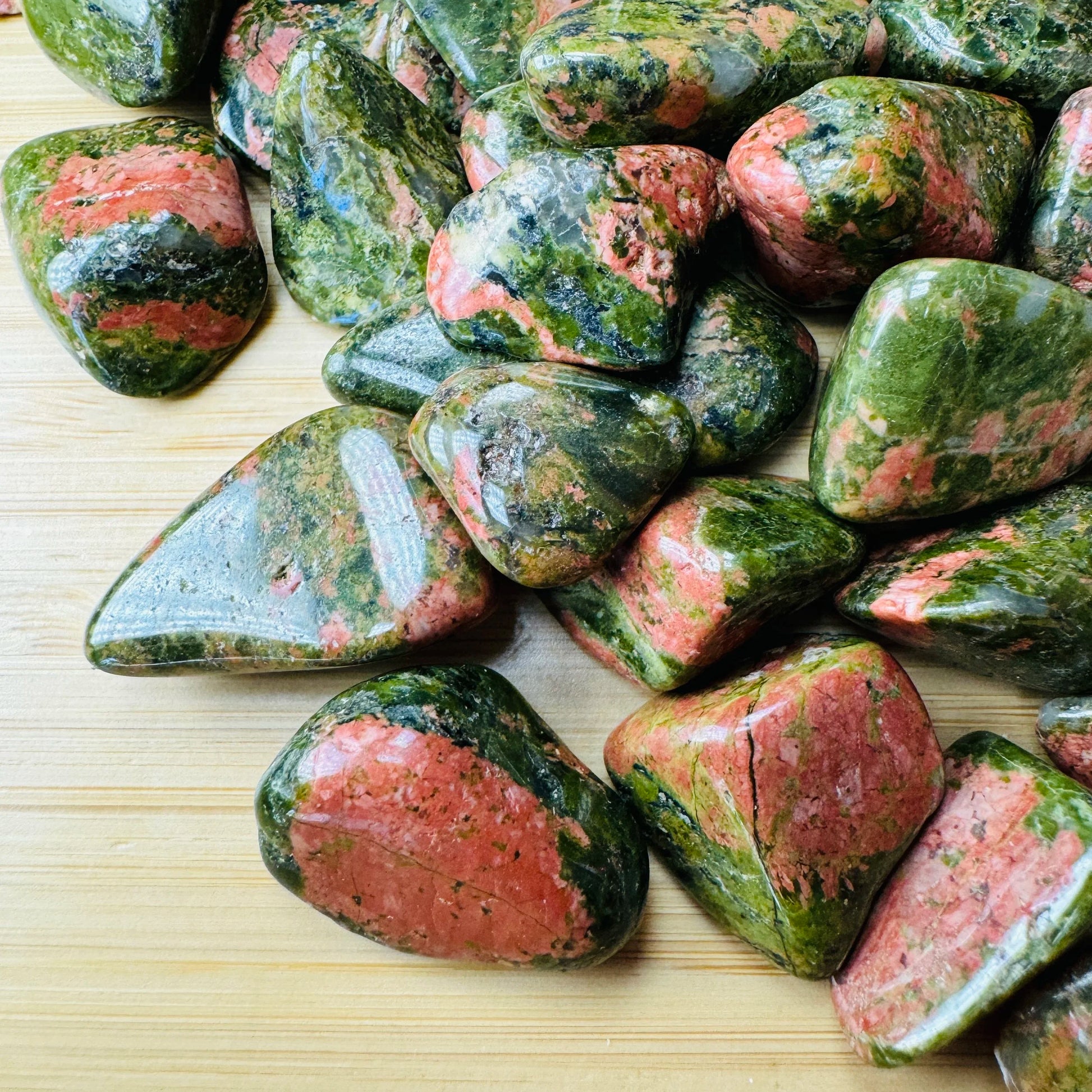 Profile shot of Unakite tumbled stone, kept close for Emotional Healing, showing natural variation.