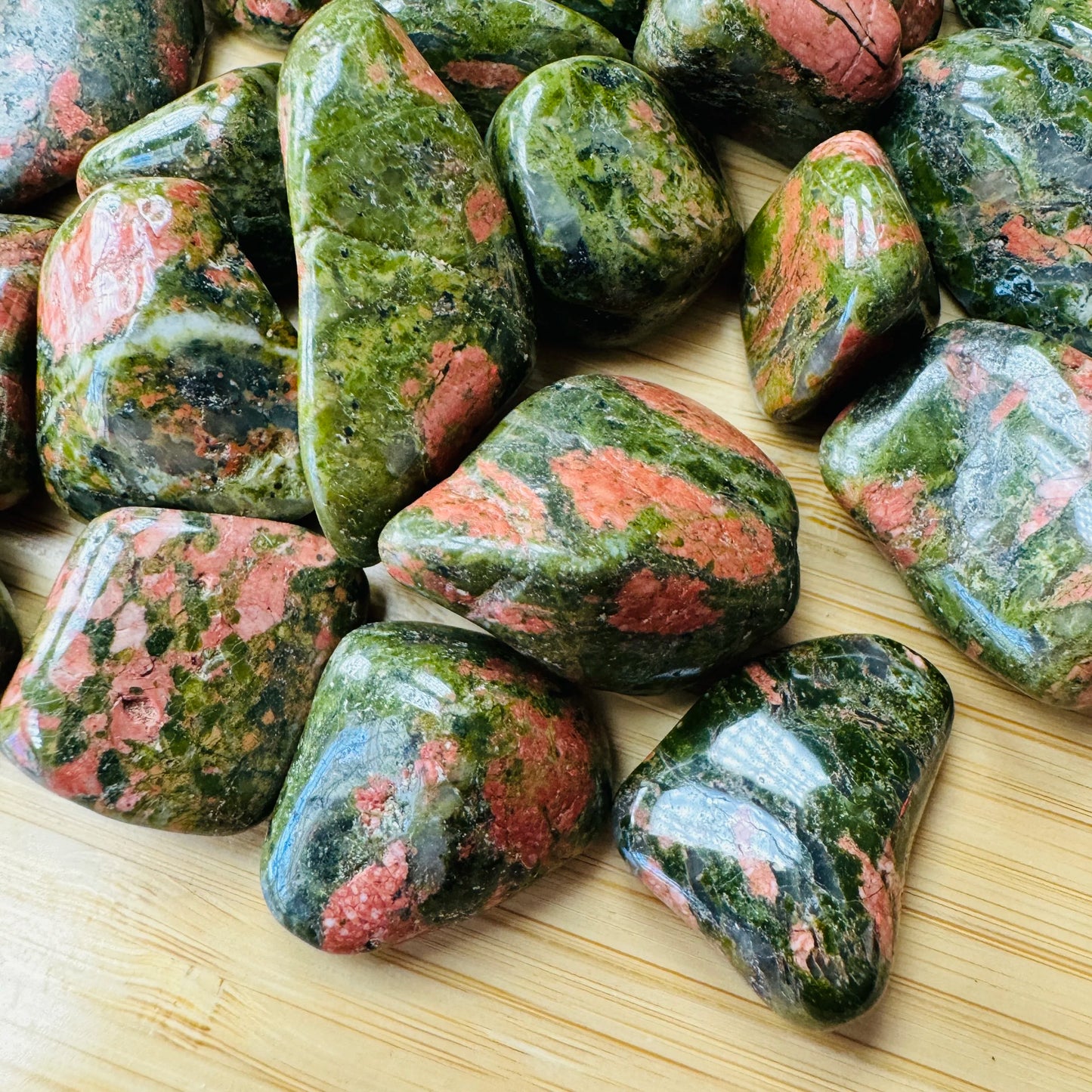 Close detail of Grade AA green Unakite tumbled stone, South Africa-sourced.