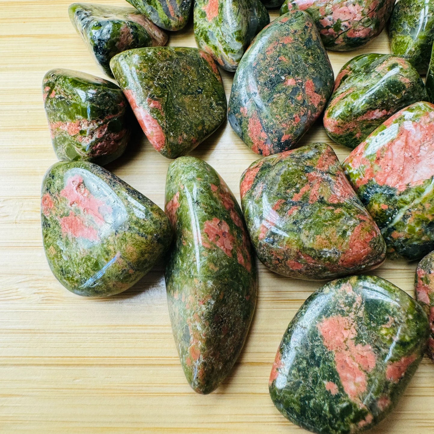 Alternate angle of Unakite tumbled stone, showing characteristic patterning.
