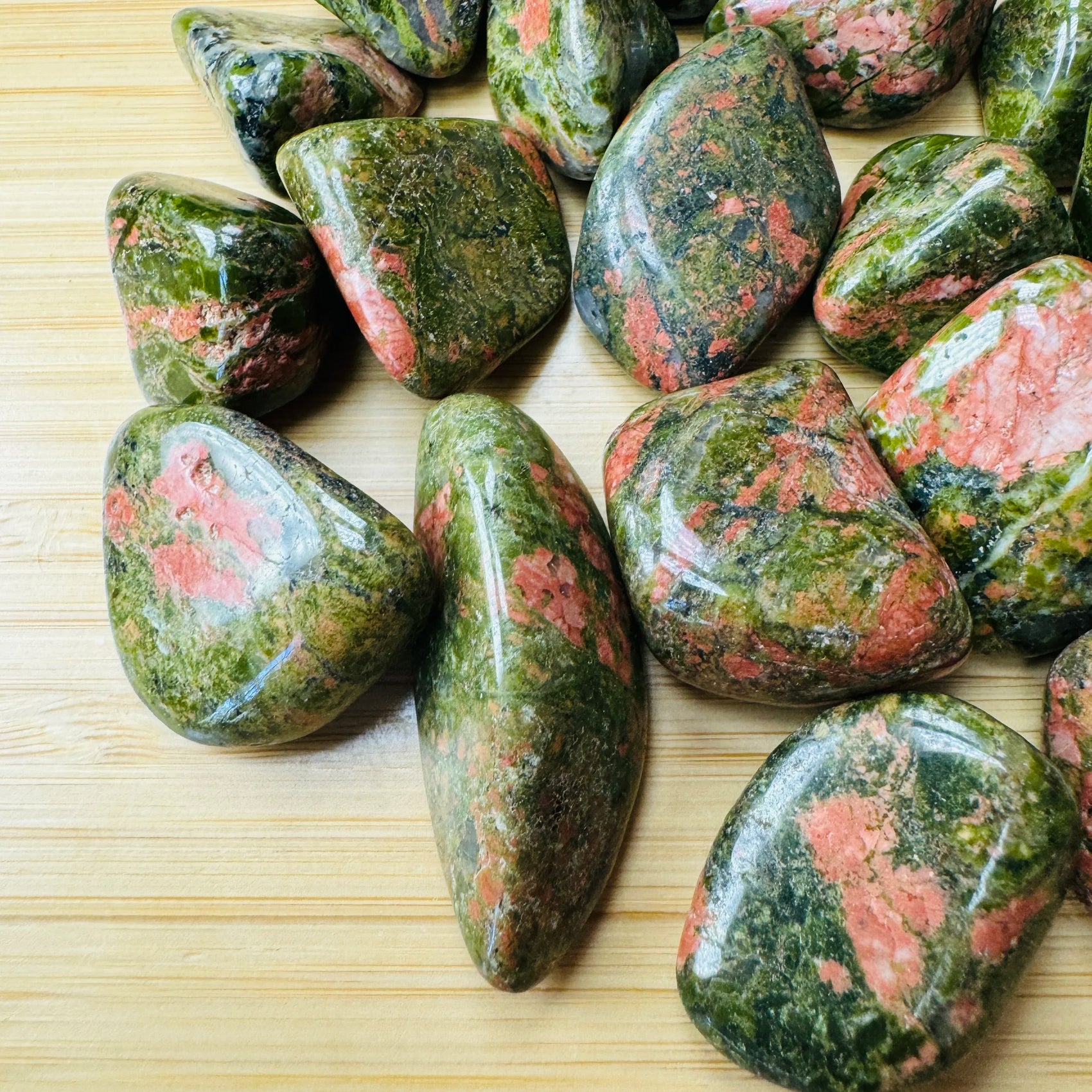 Alternate angle of Unakite tumbled stone, showing characteristic patterning.