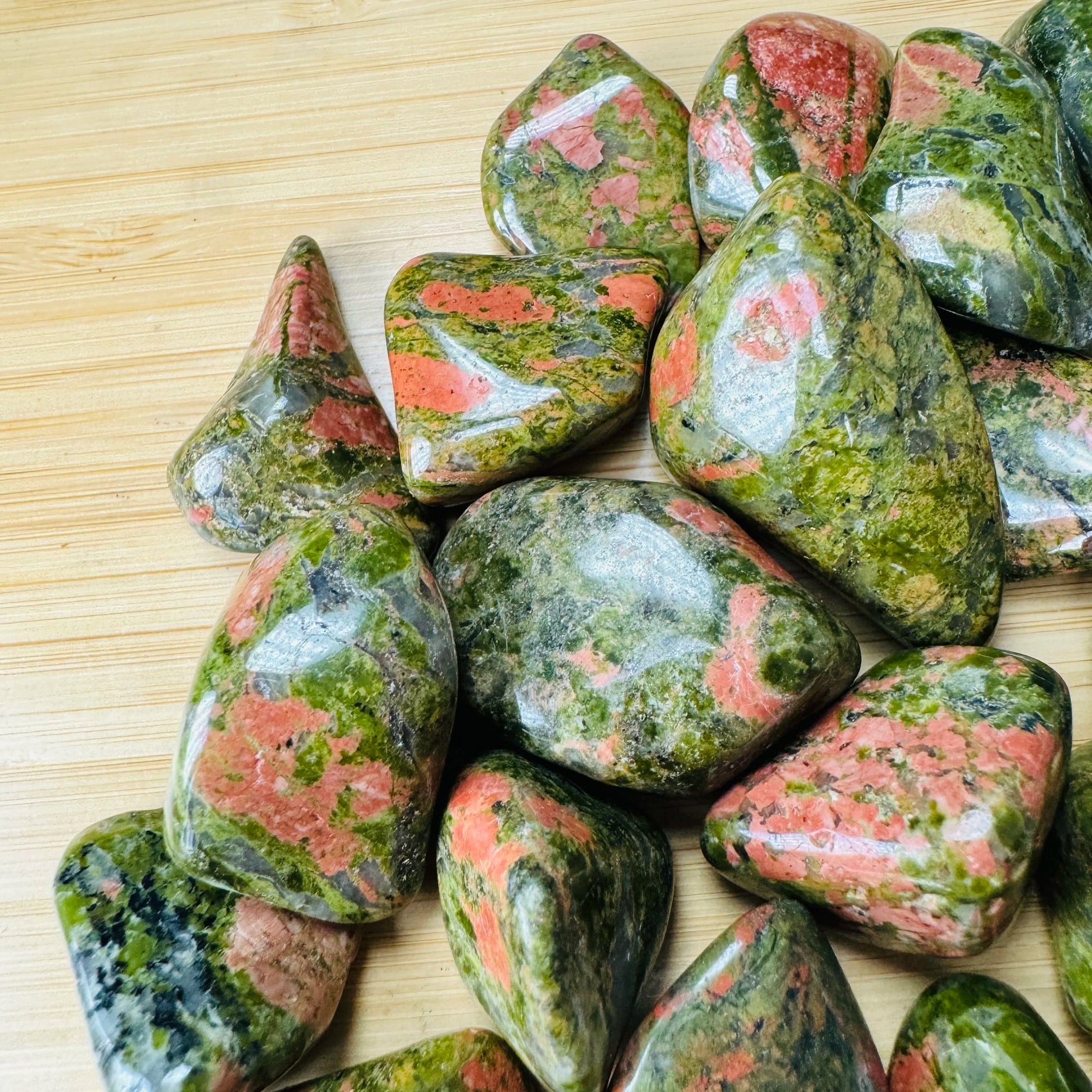 Edge view of Unakite tumbled stone, for Emotional Healing, showing matte finish.