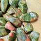Top angle of Unakite tumbled stone, hand-selected from Northern Cape, South Africa, showing characteristic finish.