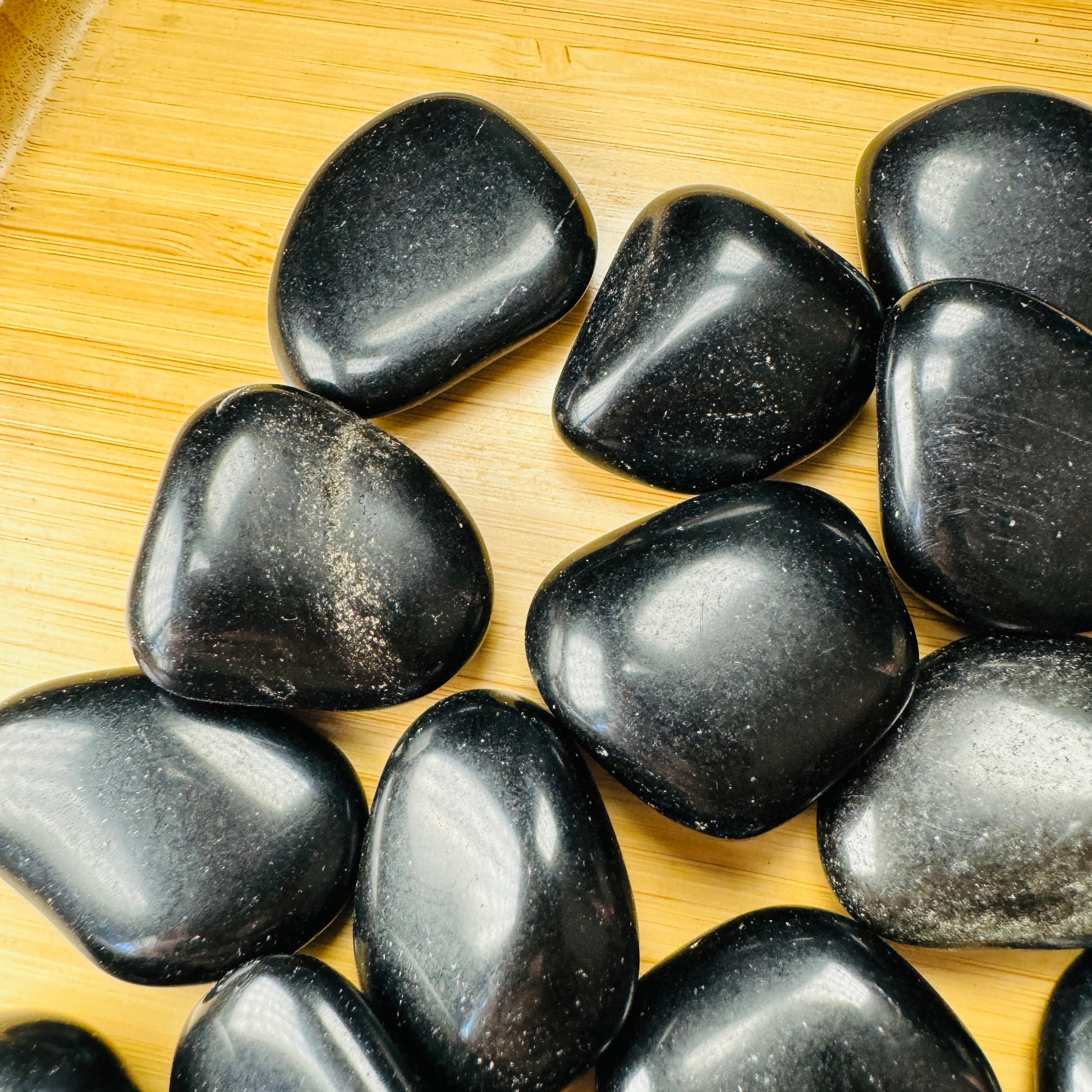 Aerial view of Grade AA Black Obsidian tumbled stone, for Protection and Grounding, sourced from Argentina.