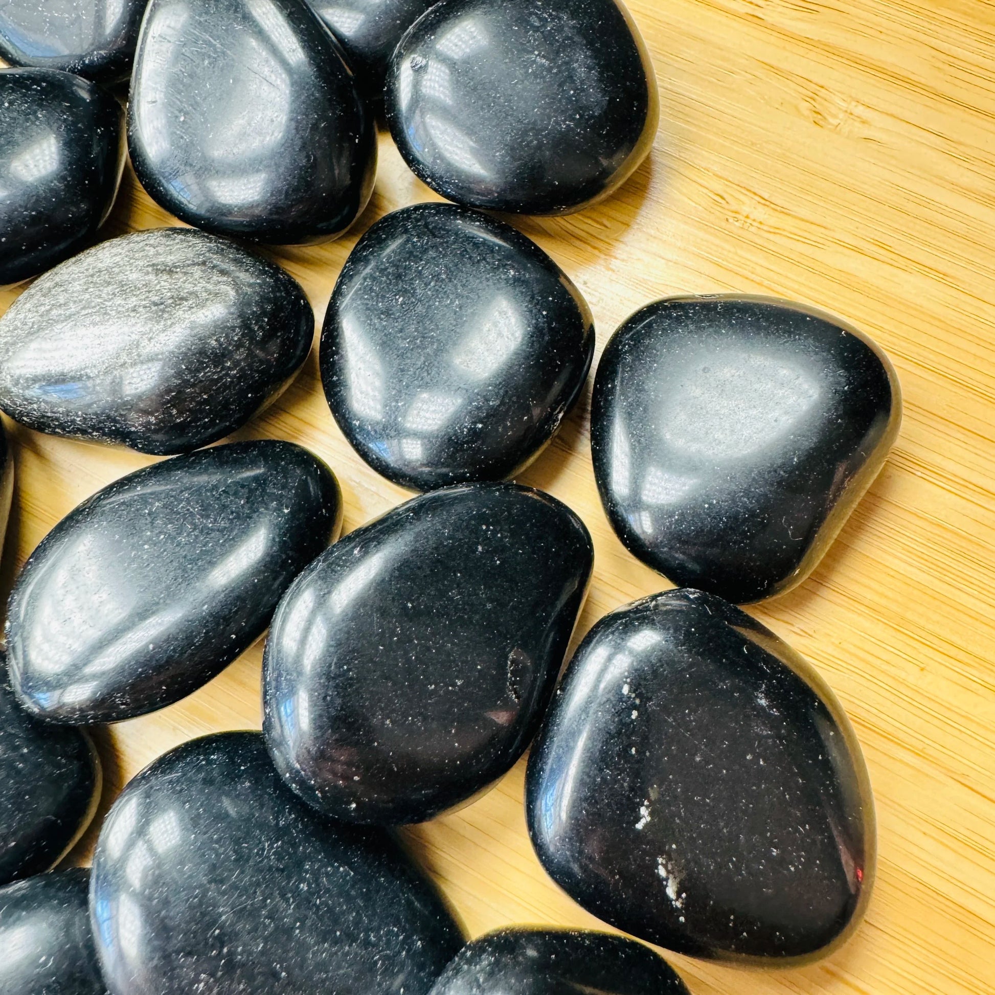Reverse side of Grade AA Black Obsidian tumbled stone, often worked with for Protection and Grounding, sourced from Salta.
