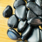 Profile shot of Black Obsidian tumbled stone, traditionally used for Protection, hand-selected from Salta Province, Argentina.