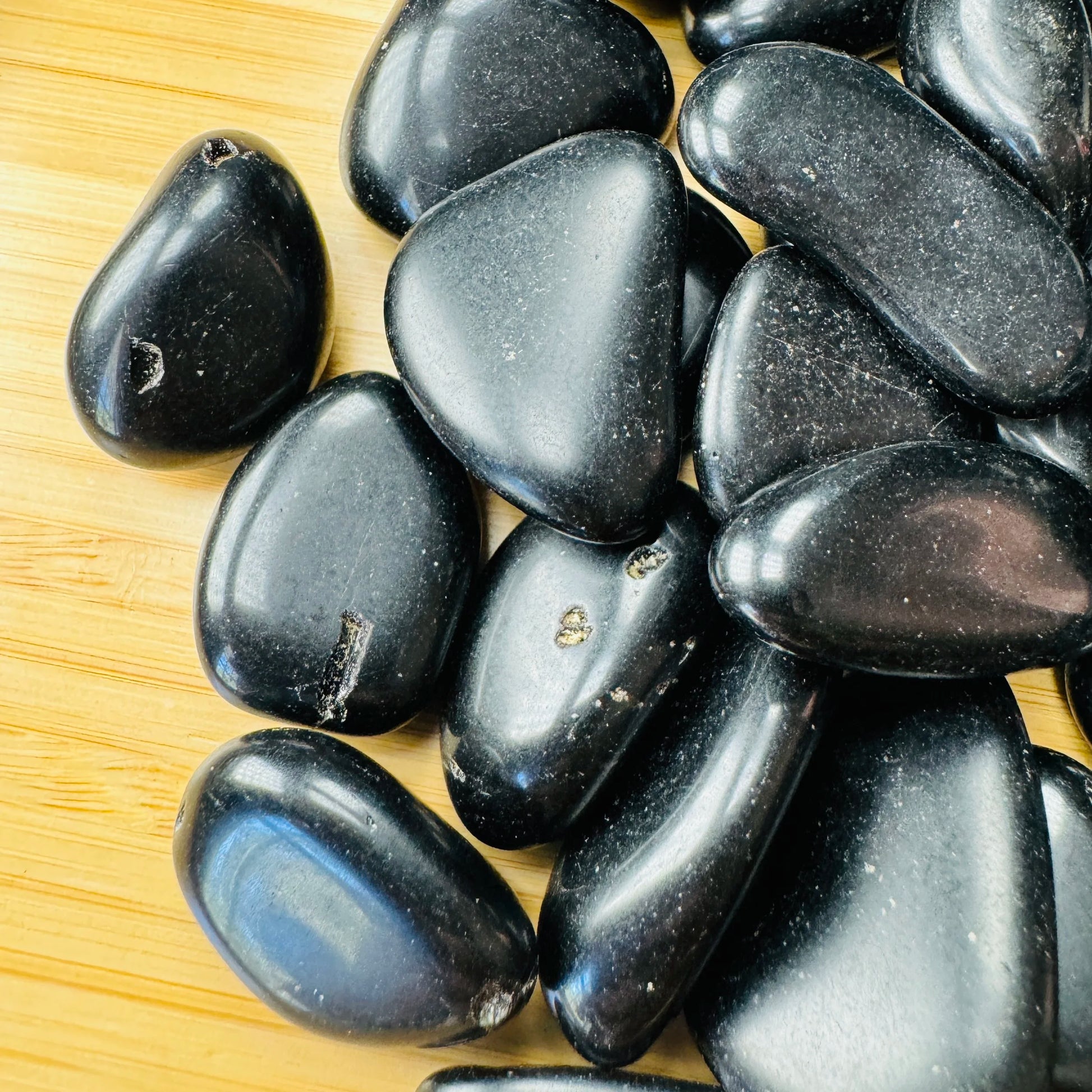 Profile shot of Black Obsidian tumbled stone, traditionally used for Protection, hand-selected from Salta Province, Argentina.