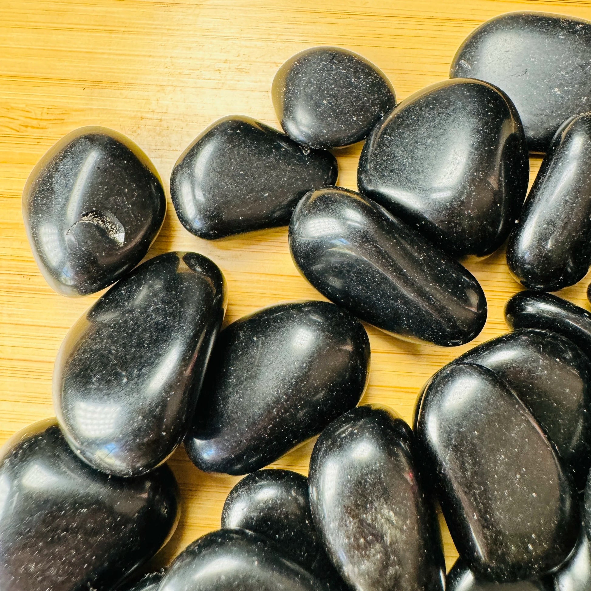 Top view of Black Obsidian tumbled stone, hand-selected from Salta Province, Argentina, linked to Protection.