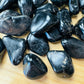 Close-up of Black Onyx tumbled stone from Brazil, soothing wellness stone for Protection