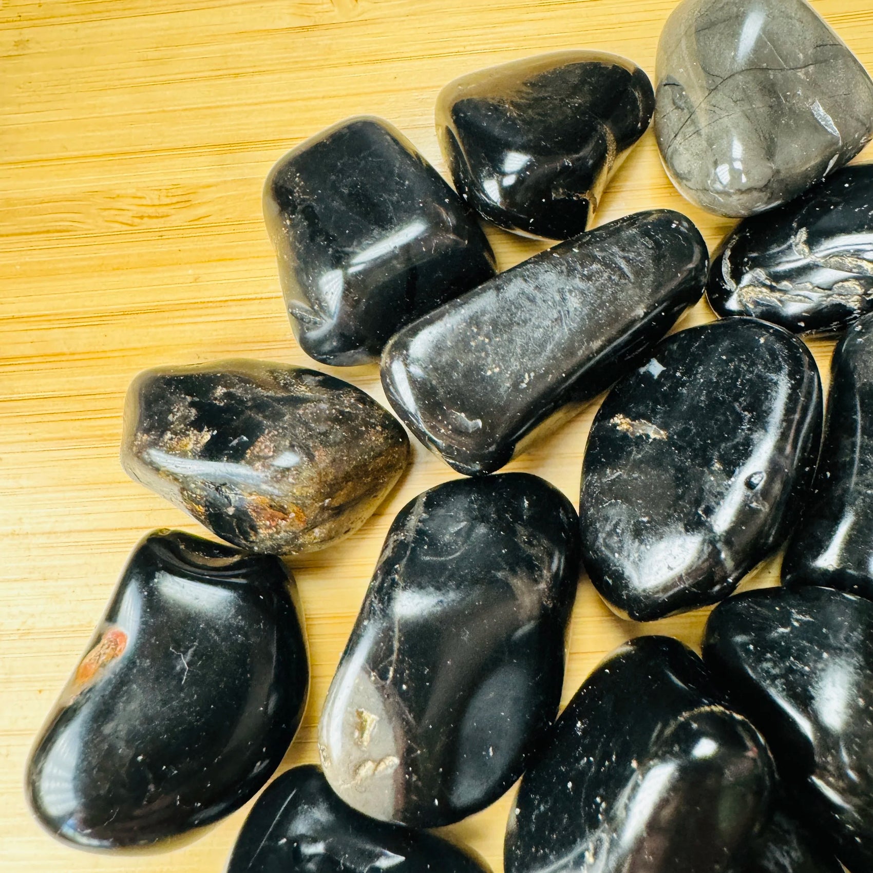 Plan view of Black Onyx tumbled stone, carried for Protection, showing translucent edges.