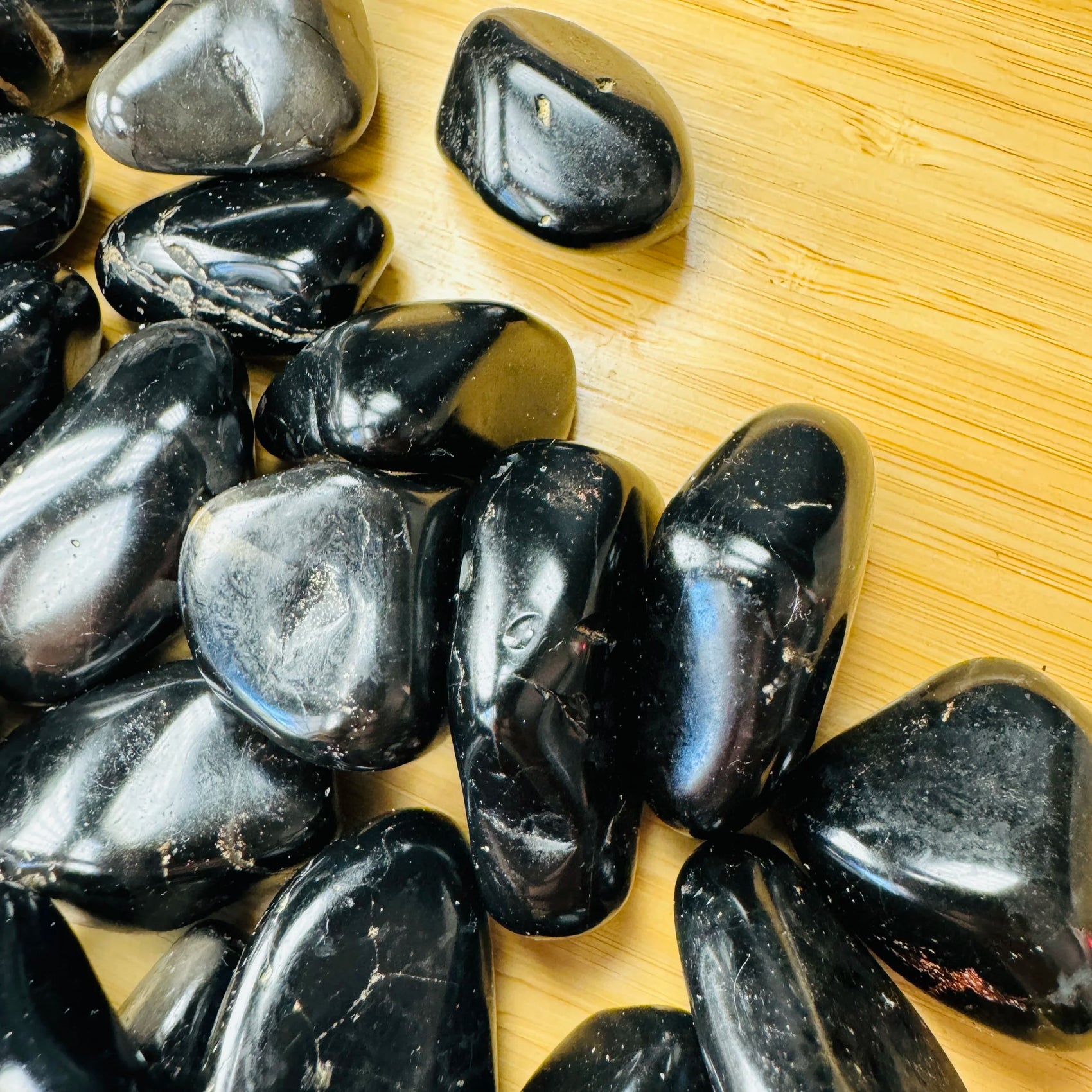Side-on view of Black Onyx tumbled stone, kept near for Protection, Brazil-sourced.