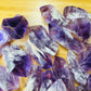 Palm-scale view of a single Amethyst raw point sourced from Bahia, Brazil.