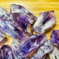 Grade aaa amethyst point held in hand for size reference