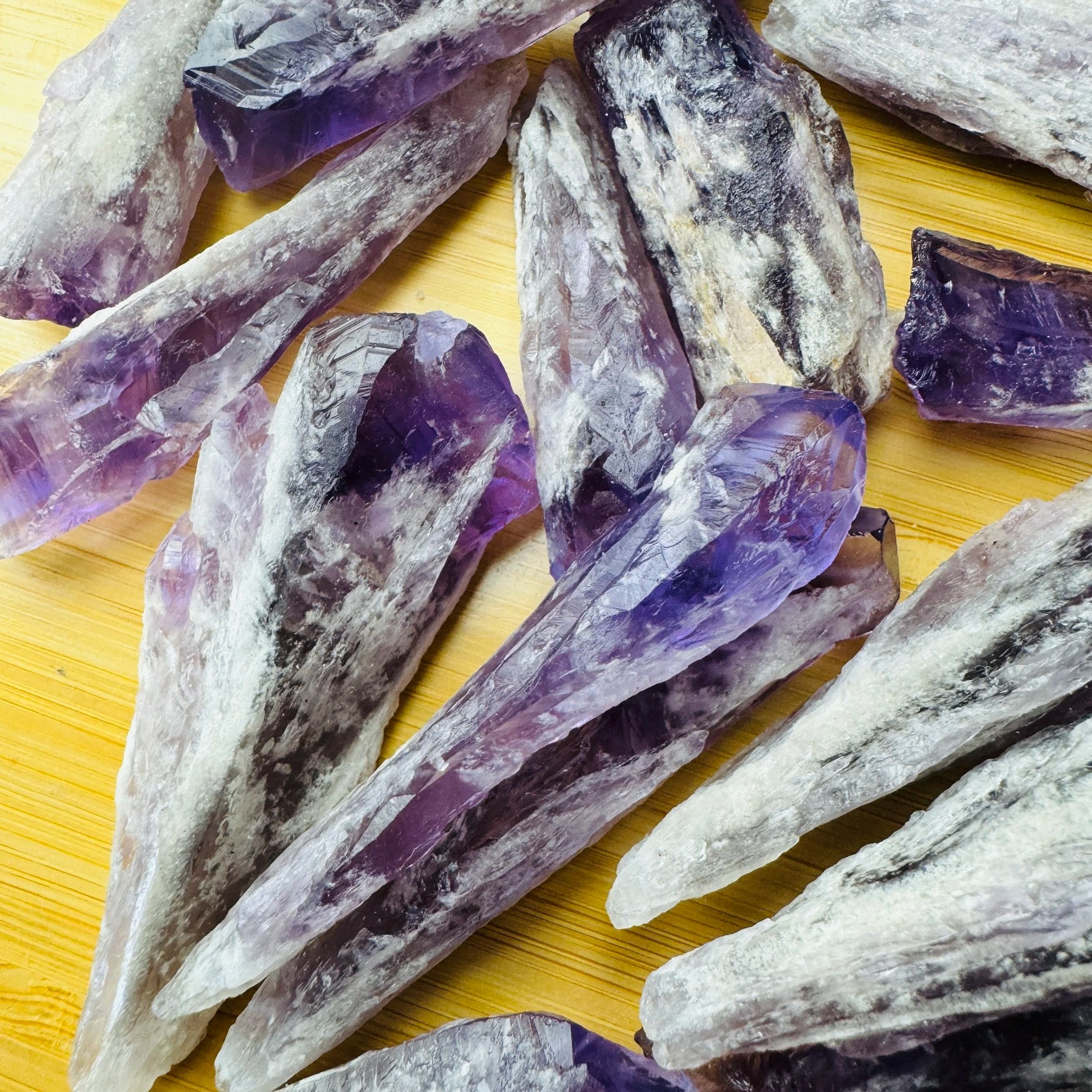 Grade a amethyst point held in hand for size reference