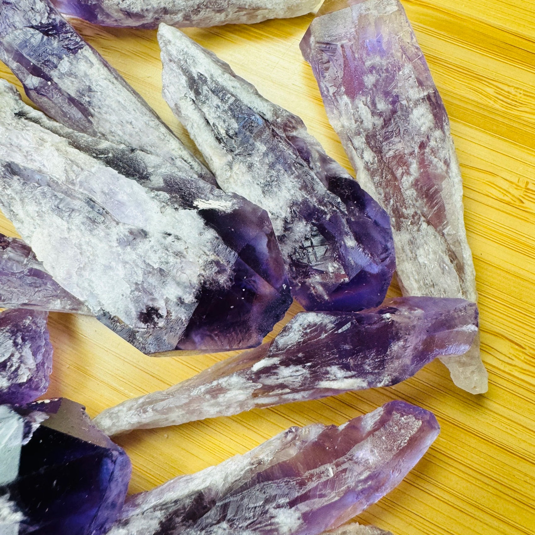 Side-on view of Amethyst raw point, sourced from Bahia, Brazil, traditionally used for Stress Relief and Sleep.