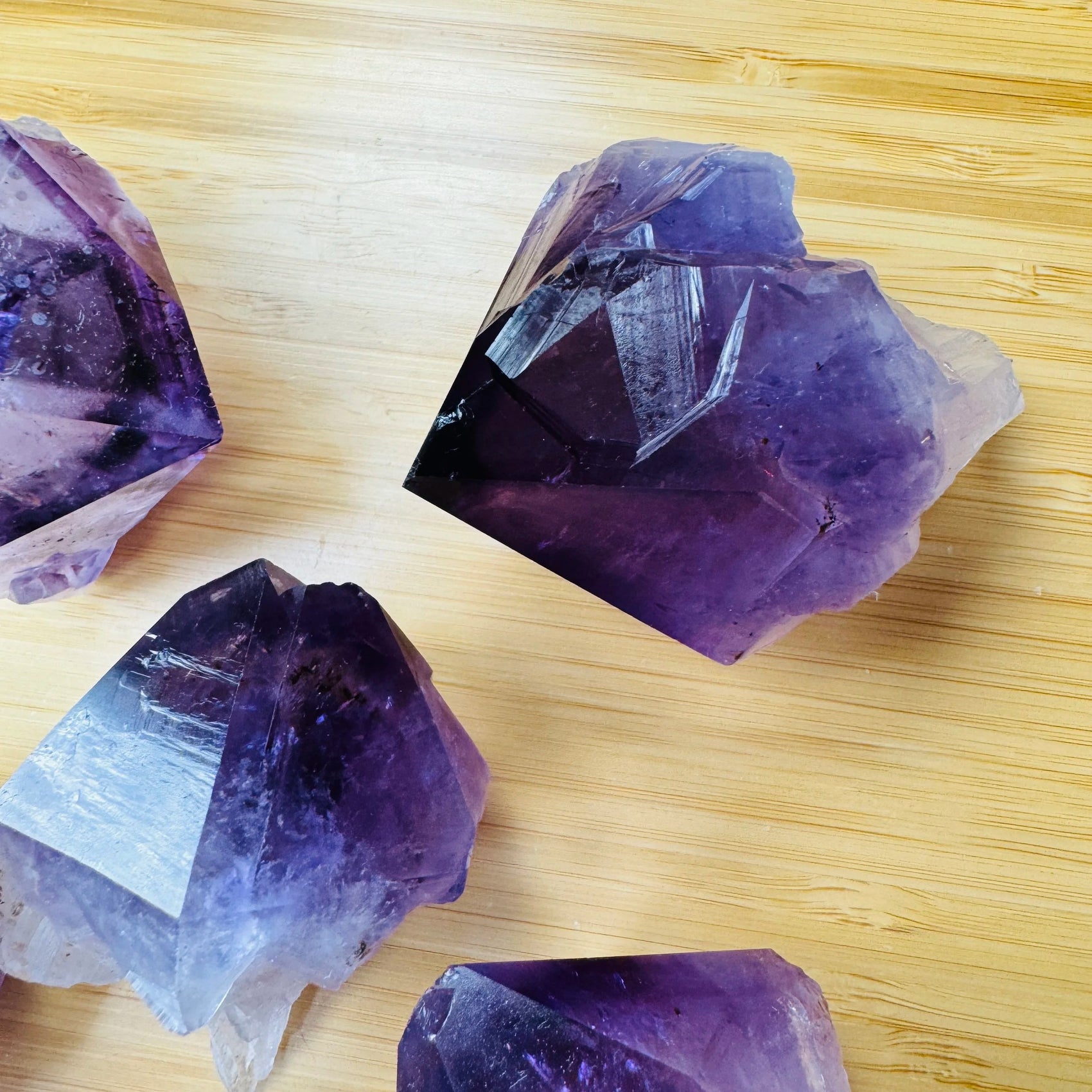 Grade aaa amethyst point held in hand for size reference