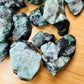 Color detail of green Emerald raw stone, sourced from Bahia, Brazil, showing characteristic finish.