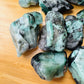 Edge-on view of green Emerald raw stone, Brazil-sourced, often paired with practices around Love.