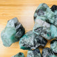 Top view of Emerald raw stone, showing earthy tone, Brazil-sourced.