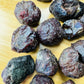 Top-side view of Grade A Garnet raw stone, showing characteristic color, sourced from Brazil.